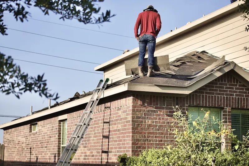 Professional roofer working on a residential roof in Tustin